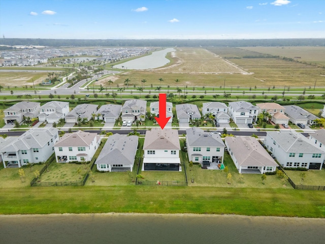 birds eye view of property featuring a water view and a residential view