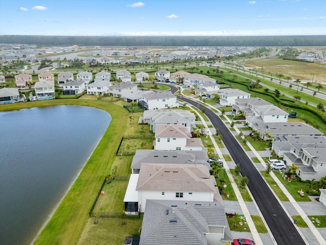 birds eye view of property featuring a water view and a residential view