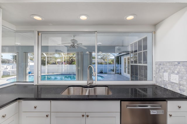 kitchen with decorative backsplash, ceiling fan, sink, dishwasher, and white cabinets