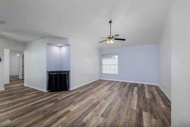 unfurnished living room with a textured ceiling, dark hardwood / wood-style flooring, and ceiling fan