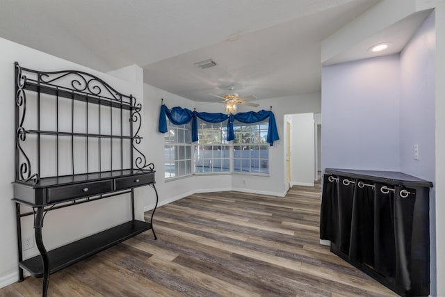 entryway with ceiling fan and dark wood-type flooring