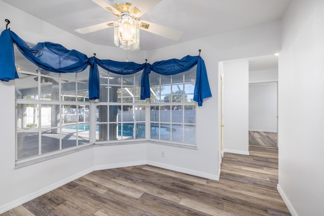 unfurnished dining area featuring ceiling fan and hardwood / wood-style flooring