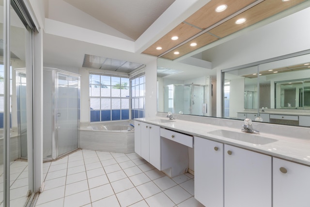 bathroom featuring shower with separate bathtub, vanity, vaulted ceiling, and tile patterned floors