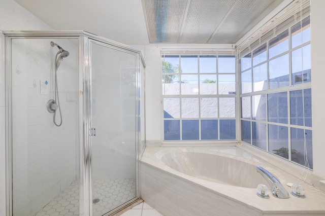 bathroom featuring tile patterned floors and independent shower and bath