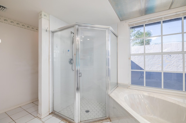 bathroom featuring tile patterned flooring and separate shower and tub