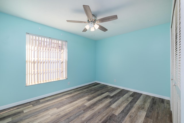 unfurnished room with ceiling fan and dark hardwood / wood-style flooring