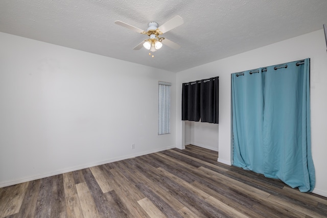 unfurnished room featuring a textured ceiling, ceiling fan, and dark hardwood / wood-style floors