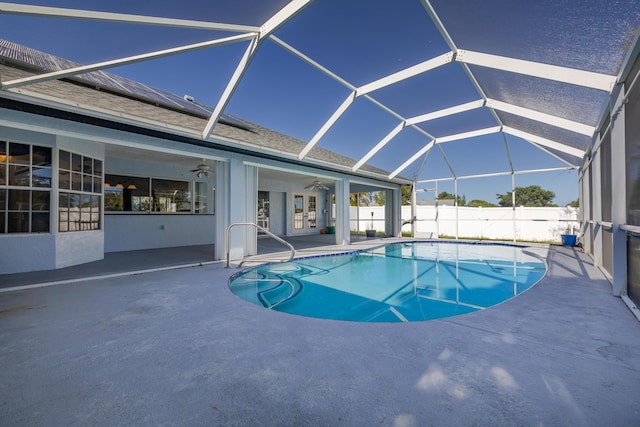 view of pool with a patio, ceiling fan, and a lanai