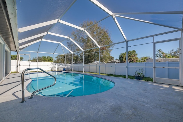 view of pool with a patio area and a lanai