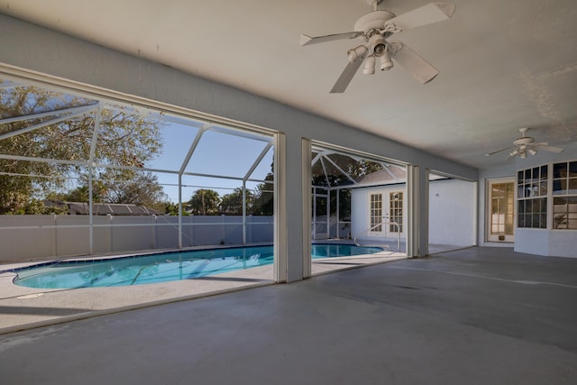 view of pool featuring glass enclosure, a patio area, and french doors