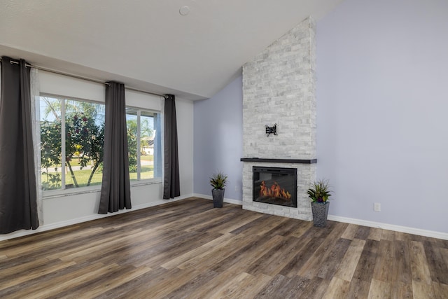 unfurnished living room with dark hardwood / wood-style flooring, a fireplace, and vaulted ceiling