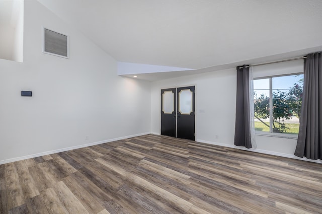 interior space featuring wood-type flooring and vaulted ceiling