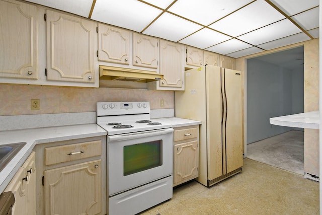 kitchen with a paneled ceiling, refrigerator, white electric stove, and light brown cabinets