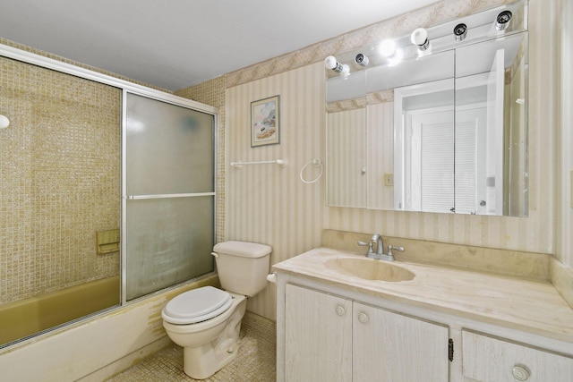 full bathroom featuring toilet, enclosed tub / shower combo, tile patterned flooring, and vanity