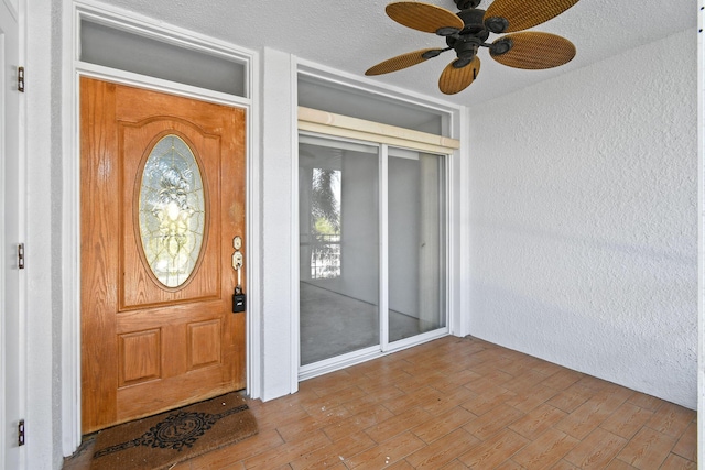 property entrance with ceiling fan