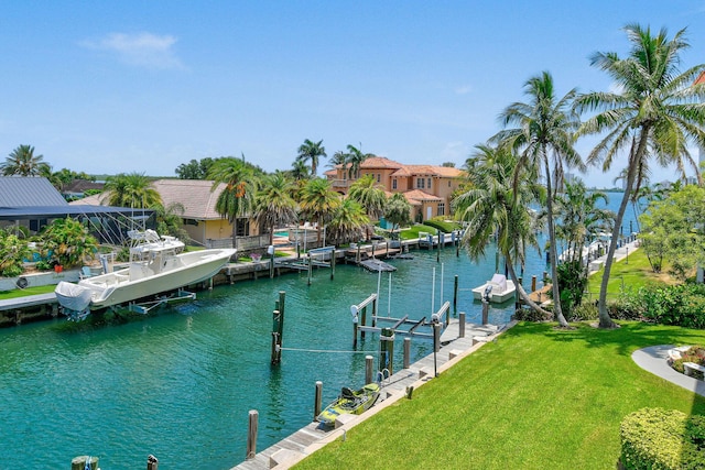 109 Paradise Harbour Blvd Unit 309, North Palm Beach, FL 33408 - dock area with boat lift, a yard, a water view, and a residential view
