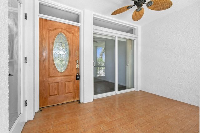 109 Paradise Harbour Blvd Unit 309, North Palm Beach, FL 33408 - entrance foyer with a textured wall, ceiling fan, and light wood-type flooring