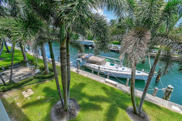 109 Paradise Harbour Blvd Unit 309, North Palm Beach, FL 33408 - dock with boat lift, a water view, and a lawn