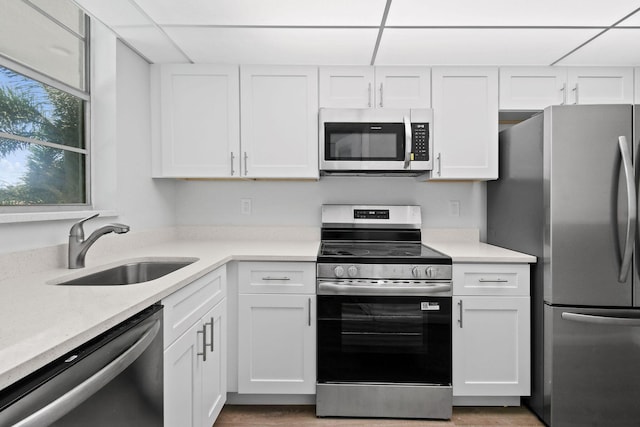 109 Paradise Harbour Blvd Unit 309, North Palm Beach, FL 33408 - kitchen featuring appliances with stainless steel finishes, white cabinetry, and light wood finished floors