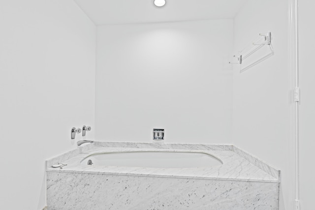 bathroom featuring a relaxing tiled tub