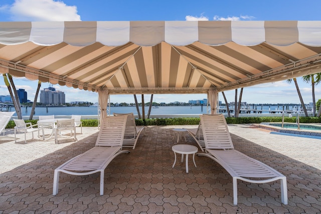 view of patio / terrace with a gazebo and a water view