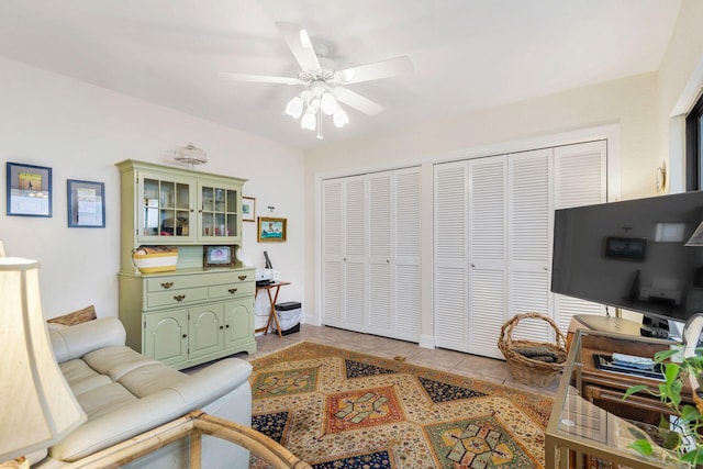 tiled living room with ceiling fan