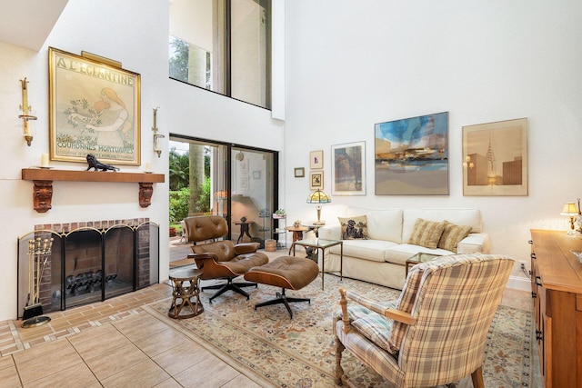 living room with light tile patterned flooring, a towering ceiling, and a fireplace