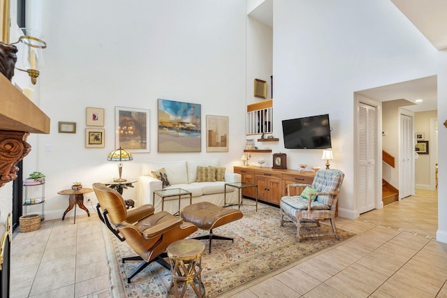 tiled living room featuring a towering ceiling