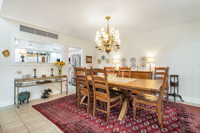 dining space featuring a chandelier and light tile patterned floors