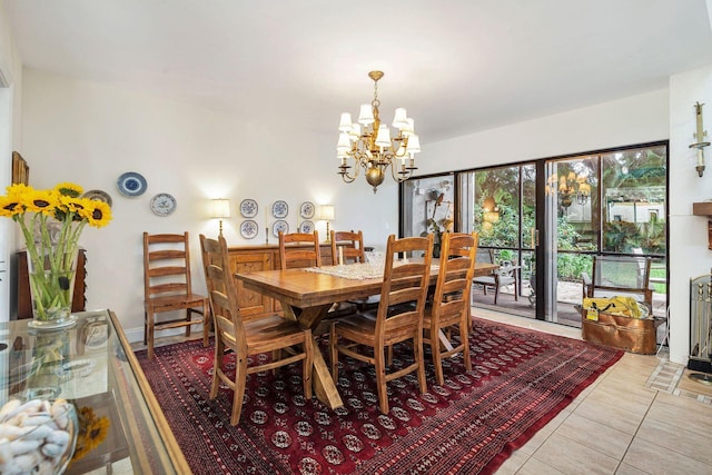 tiled dining room with an inviting chandelier