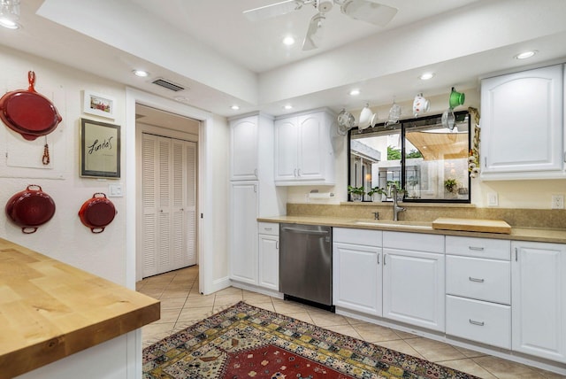 kitchen with white cabinets, sink, stainless steel dishwasher, ceiling fan, and light tile patterned floors