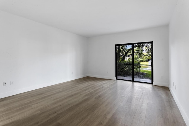 empty room with hardwood / wood-style flooring