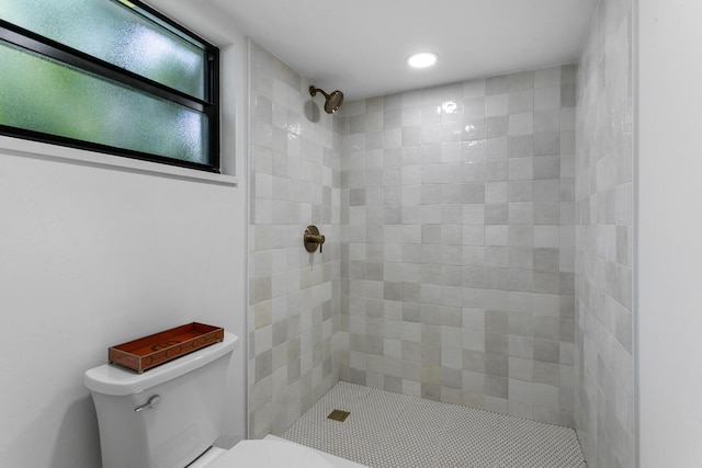 bathroom with toilet and tiled shower