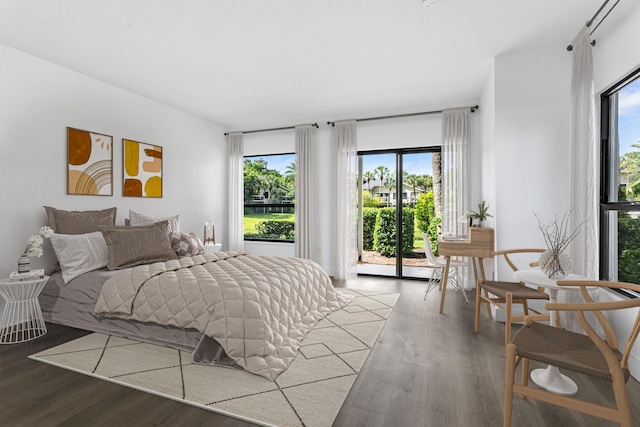 bedroom with access to outside and hardwood / wood-style flooring