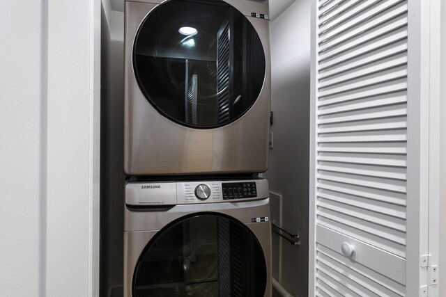 laundry area featuring stacked washer / drying machine