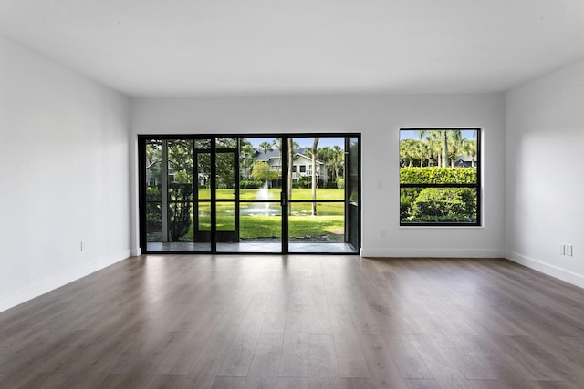 unfurnished room with dark wood-type flooring