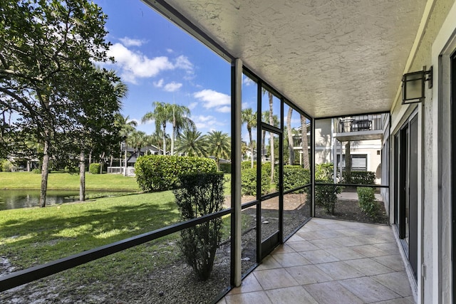 unfurnished sunroom with a water view