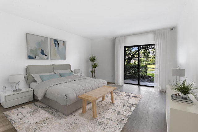 bedroom with wood-type flooring and access to outside