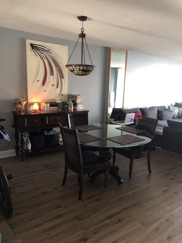 dining space with dark hardwood / wood-style floors