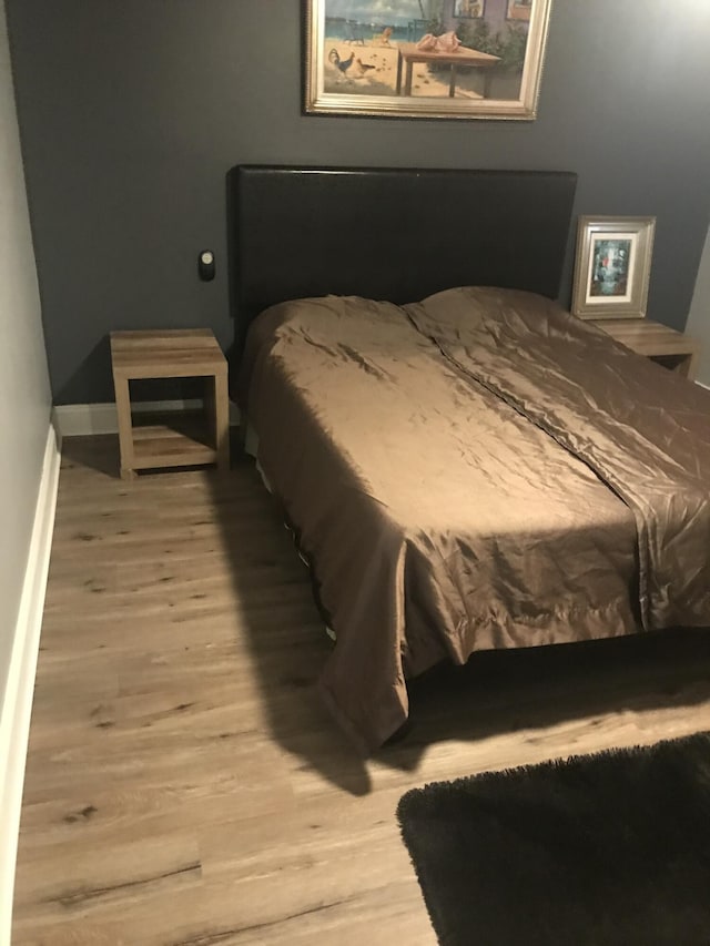 bedroom with wood-type flooring