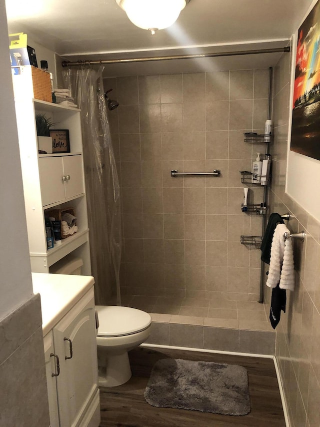 bathroom featuring toilet, vanity, wood-type flooring, and a shower with shower curtain