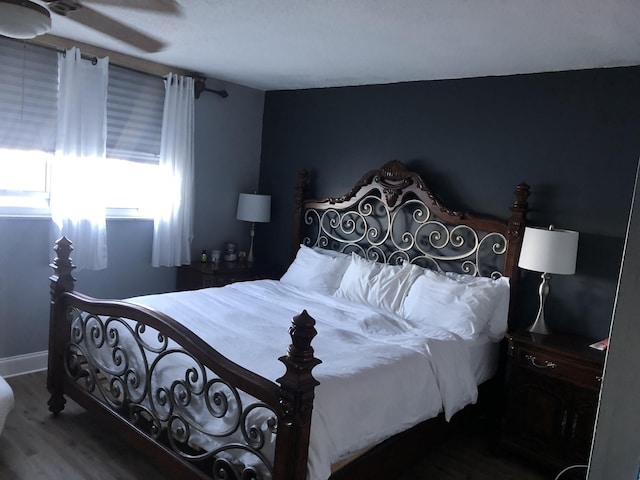 bedroom featuring hardwood / wood-style floors and ceiling fan