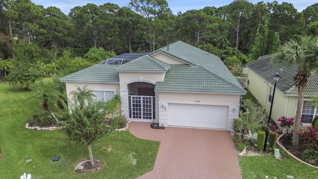 view of front of house featuring a garage and a front lawn