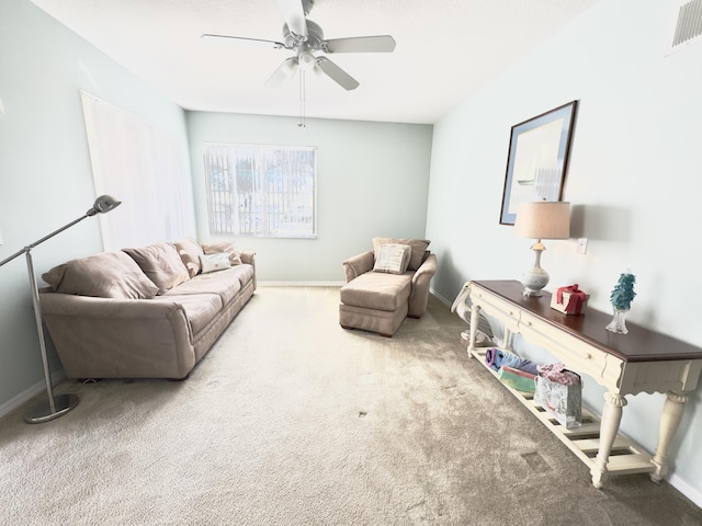 carpeted living room with ceiling fan