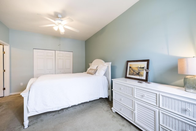 carpeted bedroom featuring ceiling fan and a closet