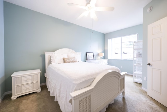 bedroom featuring ceiling fan and dark carpet