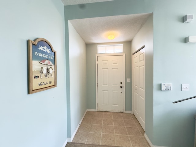 entryway with a textured ceiling