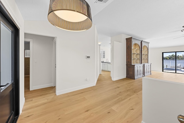 corridor with light wood-type flooring