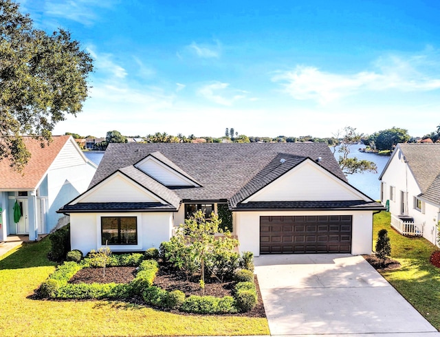 view of front of home with a front lawn and a garage