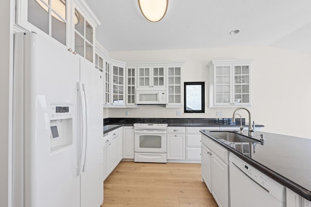 kitchen with white cabinetry, sink, white appliances, and light wood-type flooring